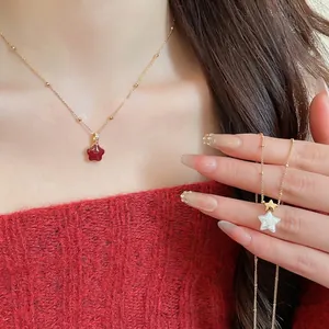 Gold plated star pendant necklace set with red enamel and white mother of pearl