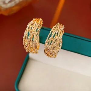 18K gold plated twisted rope hoop earrings displayed on a dark green jewelry box