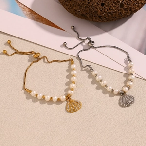 Macro detail of gold and silver shell pendant bracelets with pearls and rhinestones