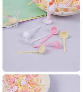 Close-up of mini macaron plastic spoons with octagonal heads for DIY crafts and dollhouses