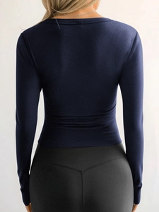Deep blue long sleeve ribbed slim fit top for women shown from a professional back view