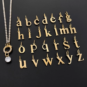 Detailed view of 26 gold stainless steel alphabet charms with a rhinestone necklace