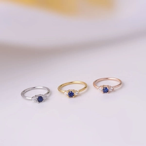 Nose rings in silver, gold, and rose gold with blue zircon stones for body piercing