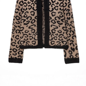 Leopard print knit cardigan featuring premium jacquard texture and black ribbed cuffs