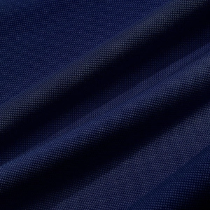 Macro shot of navy blue high-density mesh fabric texture on men's sport polo shirt