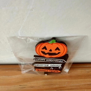 Detail of wooden Halloween pumpkin sign with Candy Warehouse and Haunted House text
