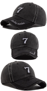 Close-up of distressed baseball cap featuring number 7 patch and Lucky Numbers embroidery