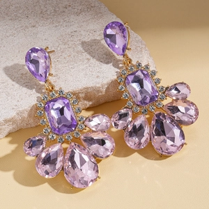 Vintage gold geometric earrings with purple crystals and teardrop drops on stone base
