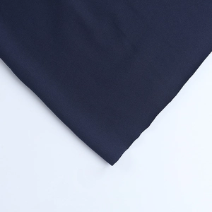 Macro shot of navy blue ribbed knit fabric showing fine texture and fiber details