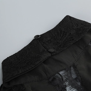 Close-up of black lace stand collar and fabric-covered buttons on evening gown