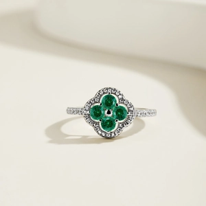 Detail of S925 silver ring featuring green zircon clover and halo pavé setting