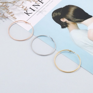 Three-color hoop earrings in rose gold, silver, and gold with woven texture detail
