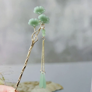 Detail of golden hairpin with green ginkgo leaves and hanging tassels for Hanfu