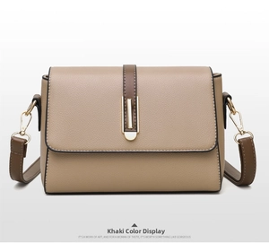 Detail view of khaki crossbody bag with litchi texture and golden metal lock clasp