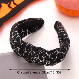 Detail of black Halloween knotted headband featuring silver spider web pattern and 39cm size