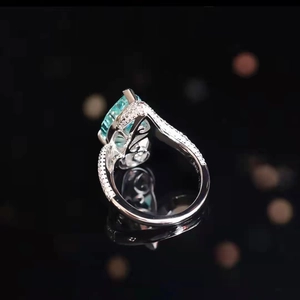 Pear cut light blue tourmaline ring in S925 silver with micro-pave halo and black background