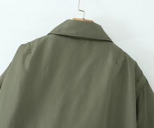 Detail of olive green vintage biker jacket collar and shoulder with glossy finish