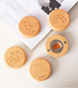 Detail of round beech wood magnetic bottle opener with cute animal laser engraving