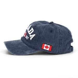 Detail view of washed navy baseball cap with Canada 1867 embroidery and side flag patch
