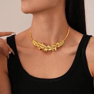 Close-up of golden irregular textured liquid metal choker necklace on a model