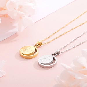 Detail of gold and silver celestial necklaces with moon and star pendants on pink background