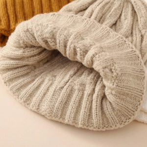 Thick cable knit beanie in oatmeal beige with soft ribbed cuff for autumn and winter wear