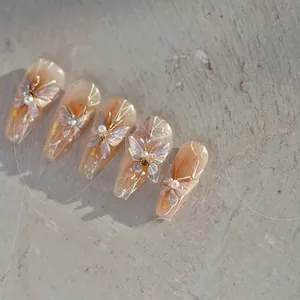 Macro view of long trapezoidal press-on nails with 3D colorful butterflies and pearls