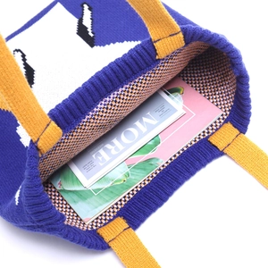 Handmade knitted tote bag in blue and yellow showing spacious interior capacity