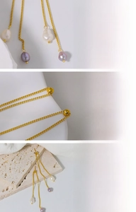 Detailed macro view of long tassel earrings with real pearls and 18K gold plating