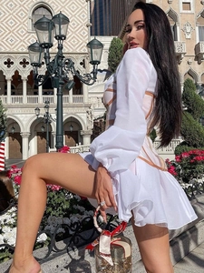Detail of white mesh hollow out French dress with waist corset and long sleeves