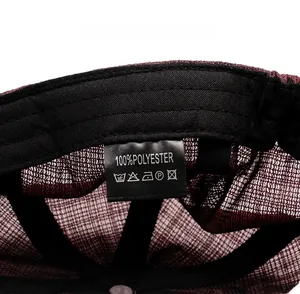 Detailed macro view of the breathable mesh fabric and care label on the red beret hat