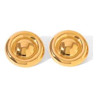 Macro shot of minimalist round gold stud earrings made of polished stainless steel