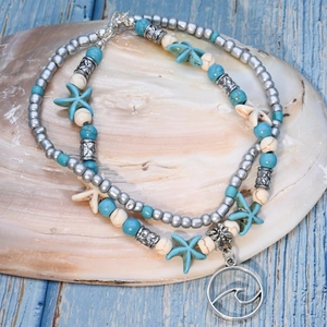 Detail of multi-layer ocean anklet with turquoise beads and starfish charms on seashell