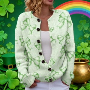 Detail of St. Patrick’s Day knit cardigan with dark green bows and black buttons