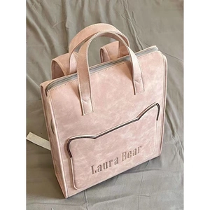 Pink matte leather laptop backpack with cat ear stitching and Laura Bear logo detail