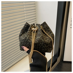 Close-up of leopard print bucket bag with gold chain strap and drawstring closure
