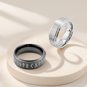 Detalle de los anillos giratorios con runas vikingas de acero inoxidable en negro y plata