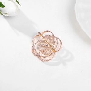 Rose gold hollow rose brooch with a secure pin clasp shown on a white background