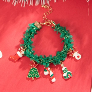 Close-up of green Christmas bracelet with enamel Santa, reindeer and tree charms