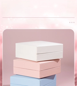 Stack of white pink and blue PU leather mini jewelry storage boxes for rings