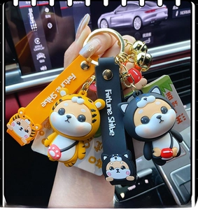 Close-up of cute Shiba Inu and tiger silicone keychains with Fortune Shiba wristbands
