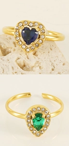Detail view of double-layer 18K gold plated rings with blue heart and green pear crystals