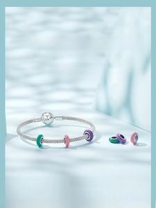 Macro view of S925 silver mesh bracelet with colorful silicone beads and engraved clasp