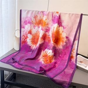 Detail of silk-like floral scarf with purple gradient petals and delicate hemmed edges