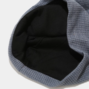 Detail shot of grey waffle knit beanie showing thick black inner lining and stitching