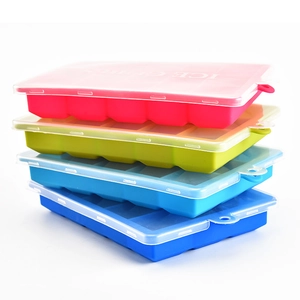 Stacked silicone 24-cavity ice cube trays with lids in four vibrant assorted colors