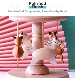Detail of hand-polished beech wood music box with three rotating carousel horses