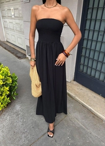 Detail of a chic strapless black maxi dress with a ruched bodice for summer fashion