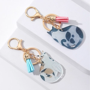 Detail of cute acrylic cat keychains with colorful tassels and gold lobster clasps