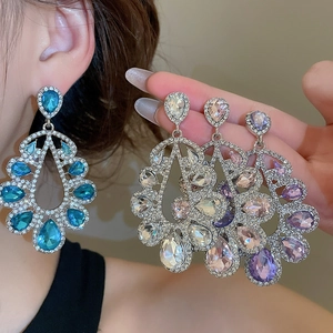 Close-up of hollow water drop earrings with silver needle and colorful crystals
